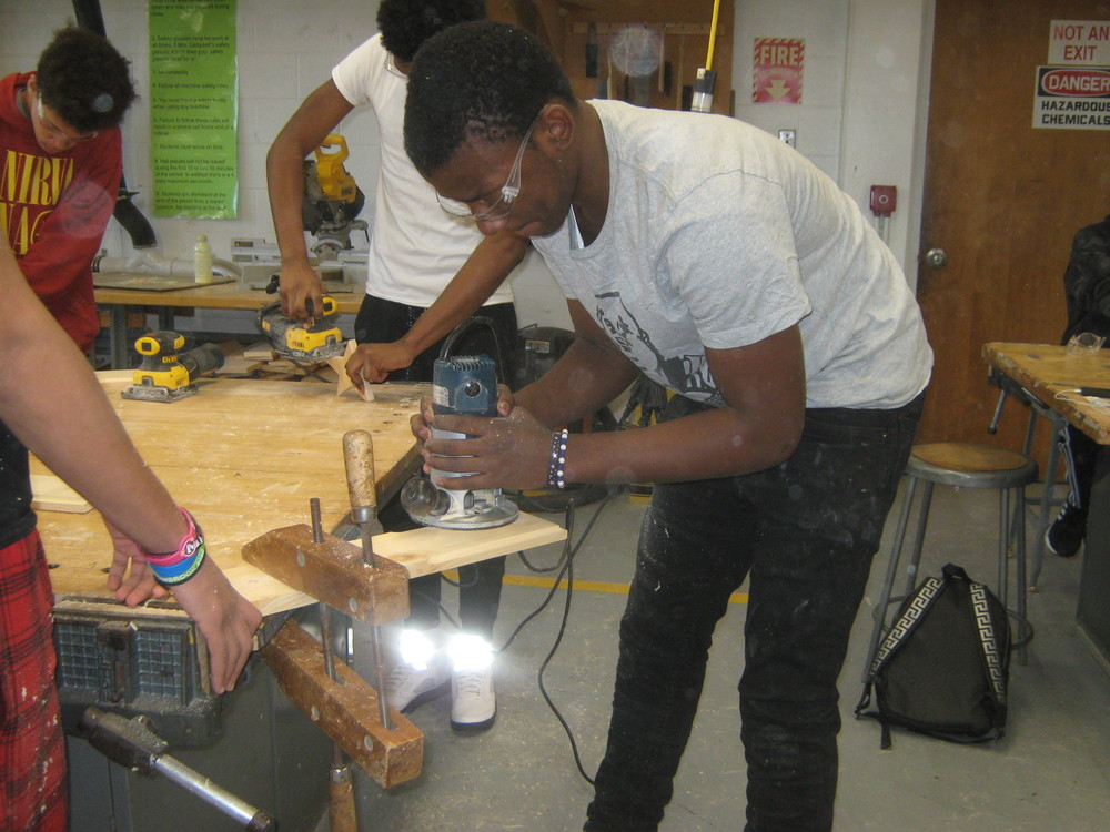 Students practice skills using a router