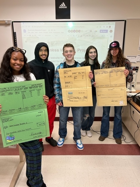 Students in Mrs. Schenker's and Mr. Mroz's Financial Literacy classes created oversized paycheck and pay stubs as they calculated payroll taxes and other deductions! 