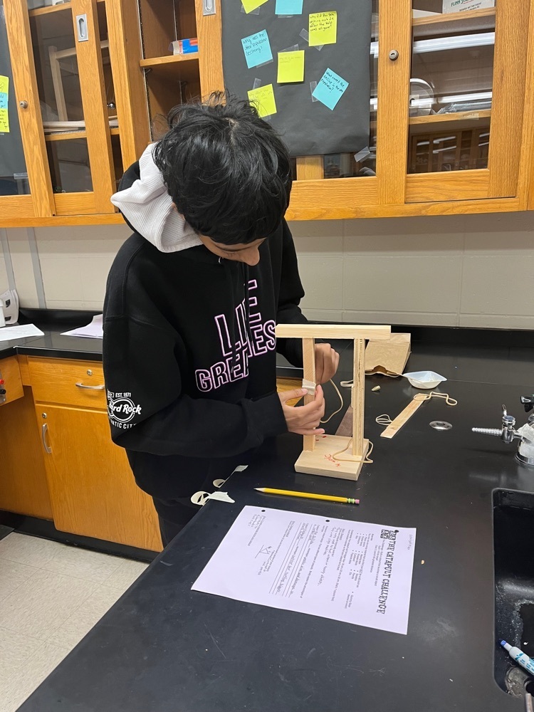 Student building catapult 