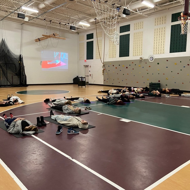 students laying on yoga mats 